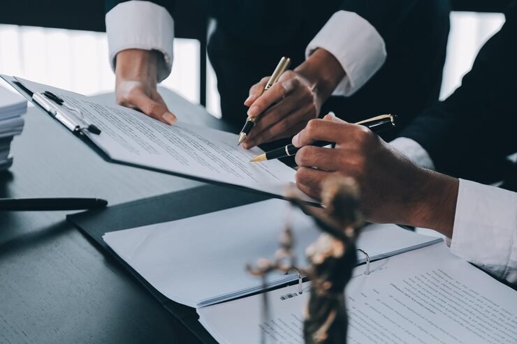 business-lawyers-discussing-contract-papers-with-brass-scale-desk-office-law-legal-services-advice-justice-law-concept-picture-with-film-grain-effect_265022-61190